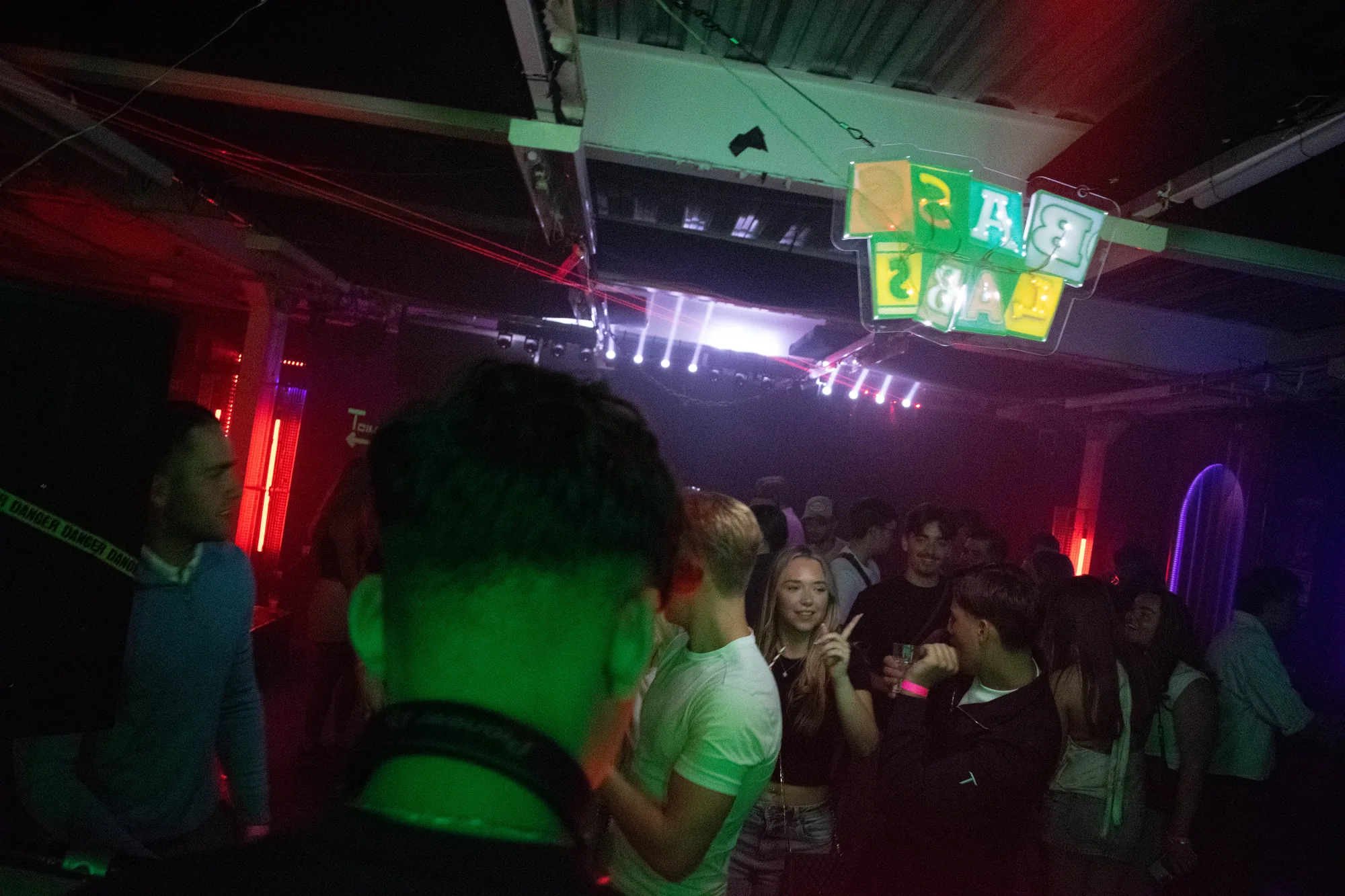 A packed Sunset Underground crowd beneath the Bass Labs sign